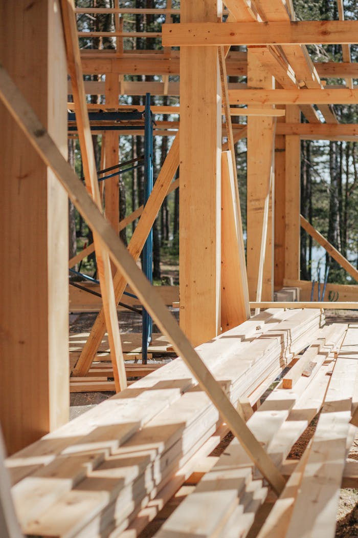Naslovnica Sunlit construction site with wooden lumber arranged in rows. Perfect for building projects.